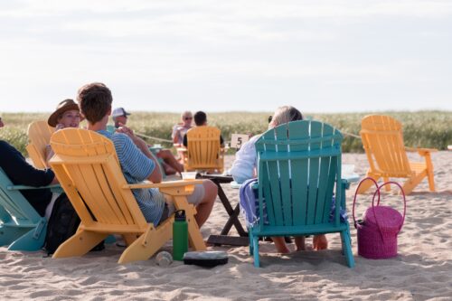 people on the beach in chairs