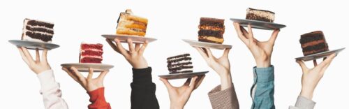 row of cake slices being held up
